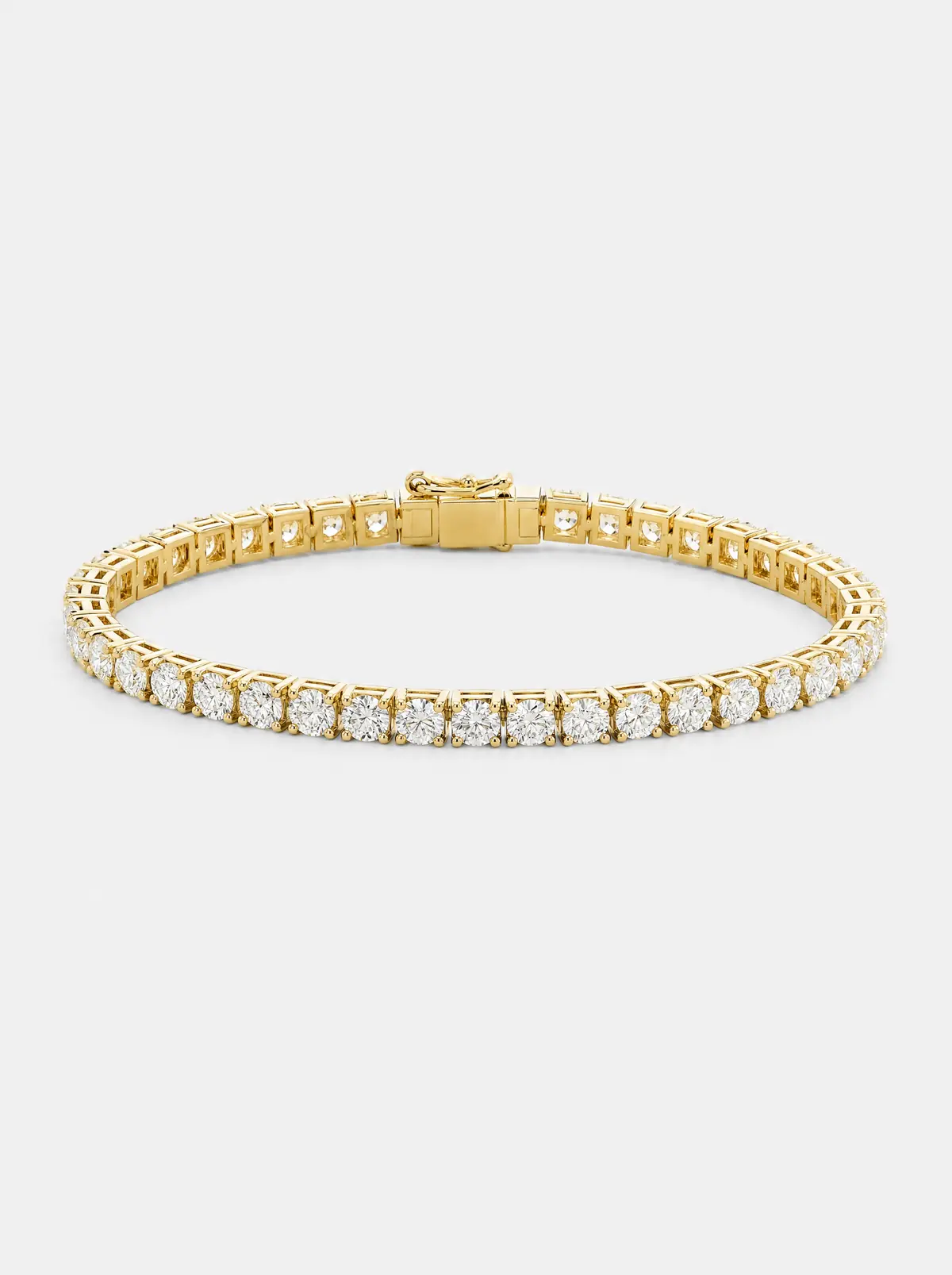 A yellow-gold diamond tennis bracelet on light grey (illustrative, generated)
